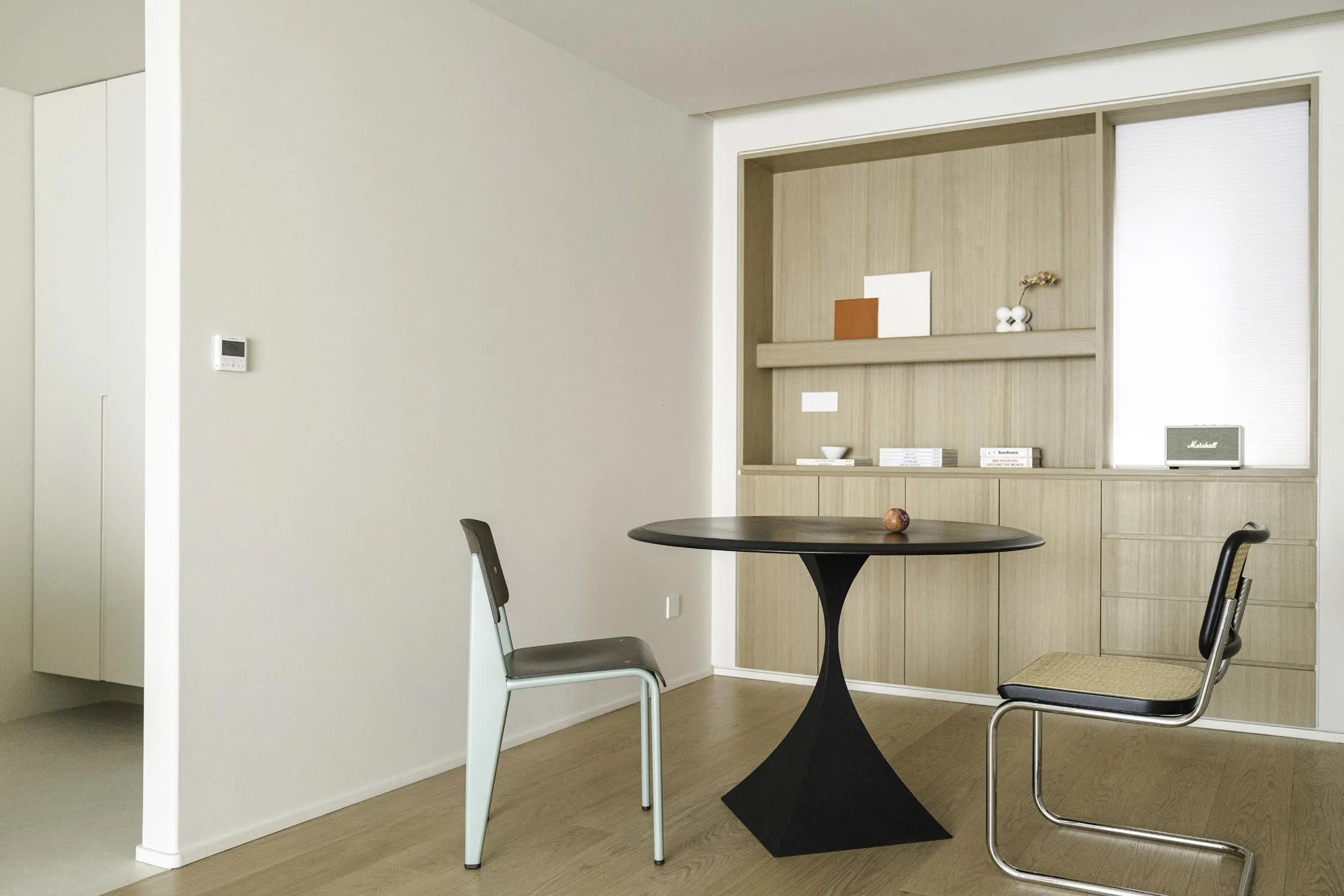 Bright cream kitchen and dining space of K Apartment