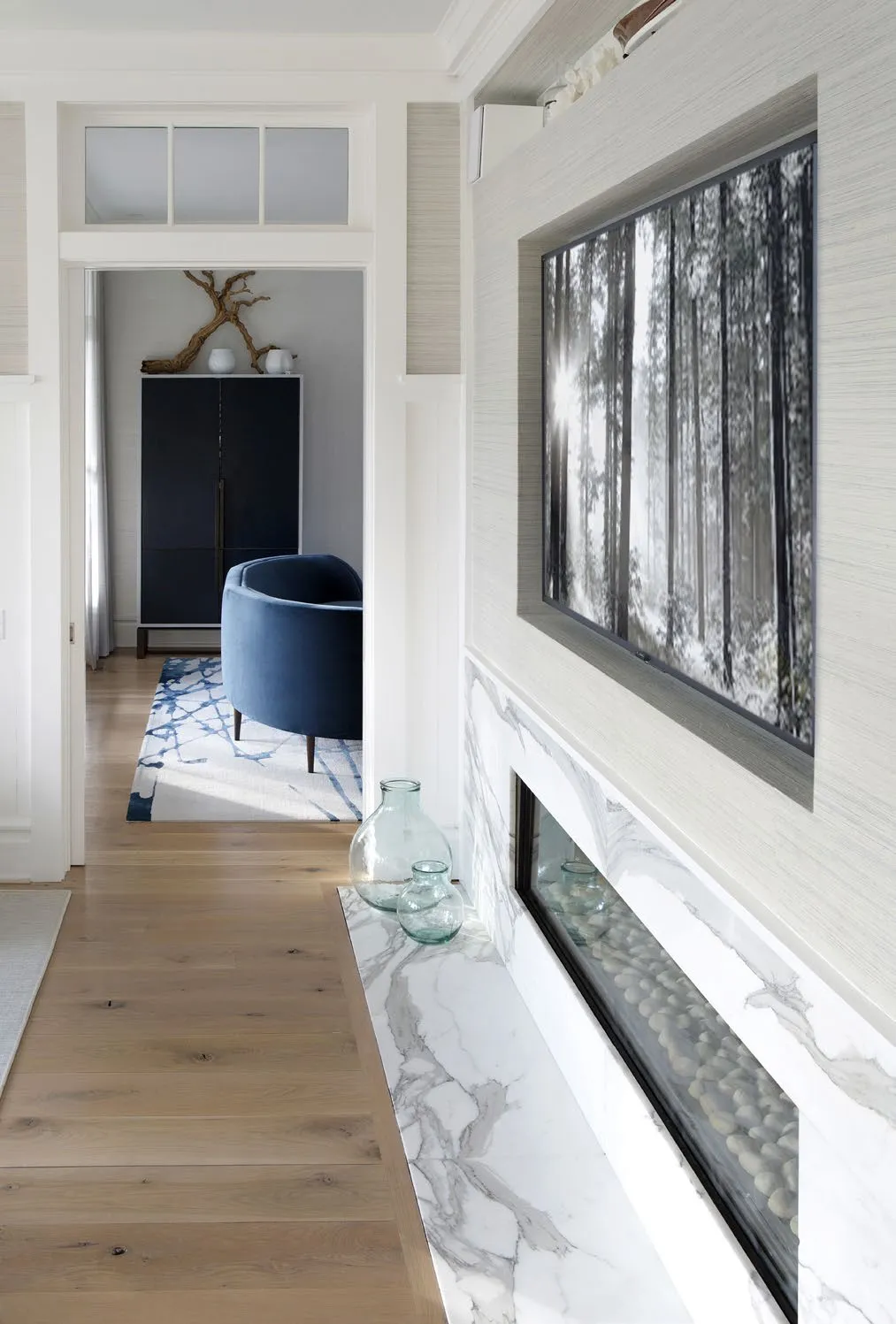 A long view through L Beach House with timber floors and framed openings